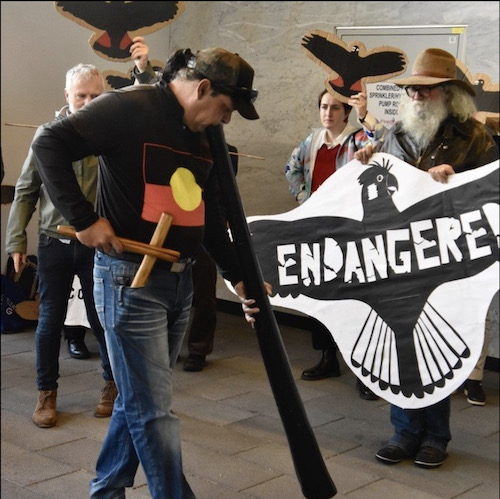 Daniel Garlett with didge and Aboriginal flag